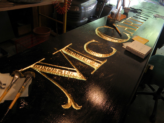 Paul Parpard's gold leaf work on his carved sign
